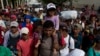 Guatemala -- A Honduran migrant carries a little girl on his shoulders as part of a caravan making their way to the U.S., in Chiquimula, Guatemala, Tuesday, Oct. 16, 2018