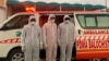 PAKISTAN -- Pakistani medical staff stand at the Pakistan-Iran border, which was closed due to the outbreak of coronavirus in neighboring Iran, in Taftan, February 25, 2020